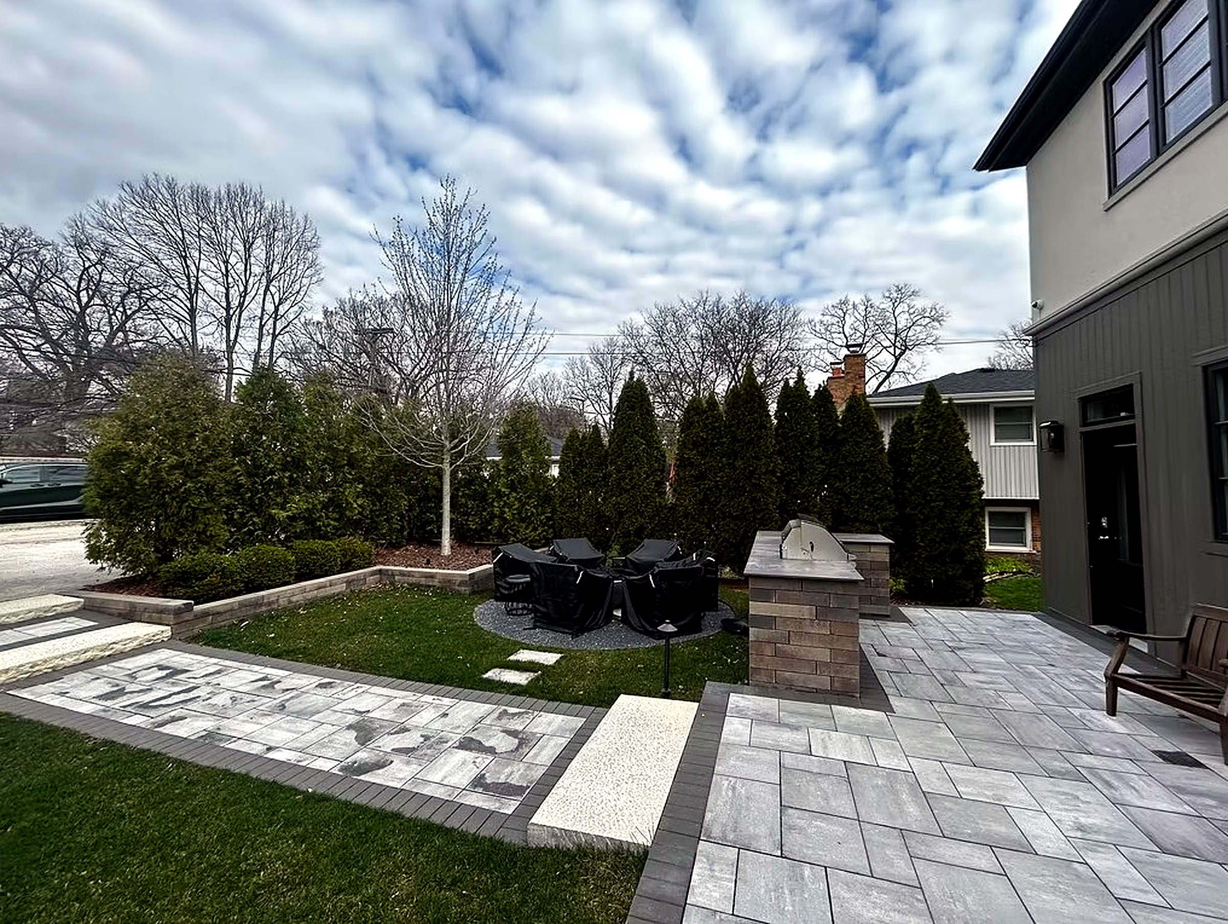 Freshly striped lawn with evergreen accent planting
