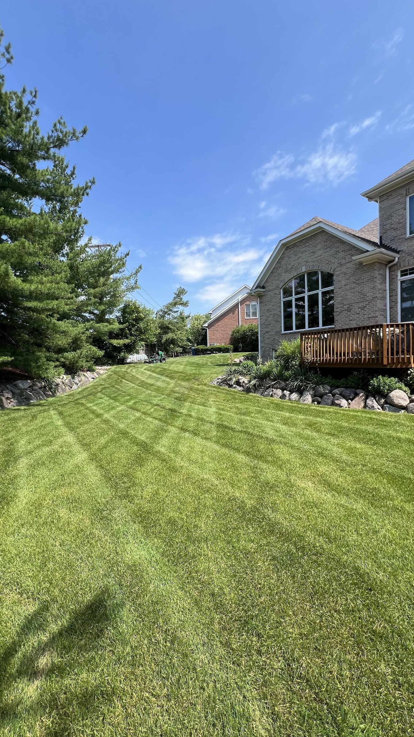 Striped slope lawn at a brick suburban home