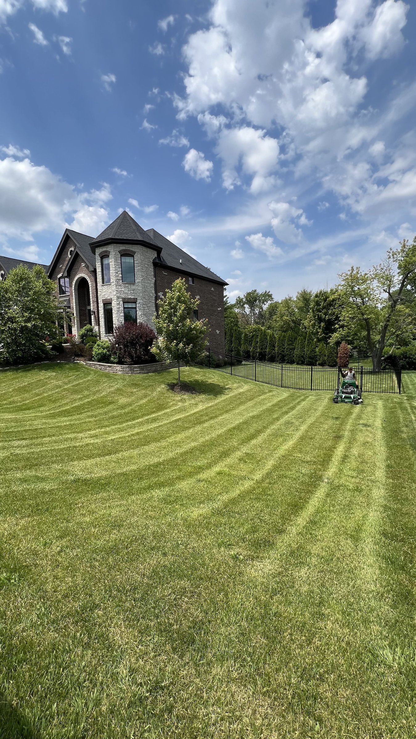Estate front lawn with mower and professional striping