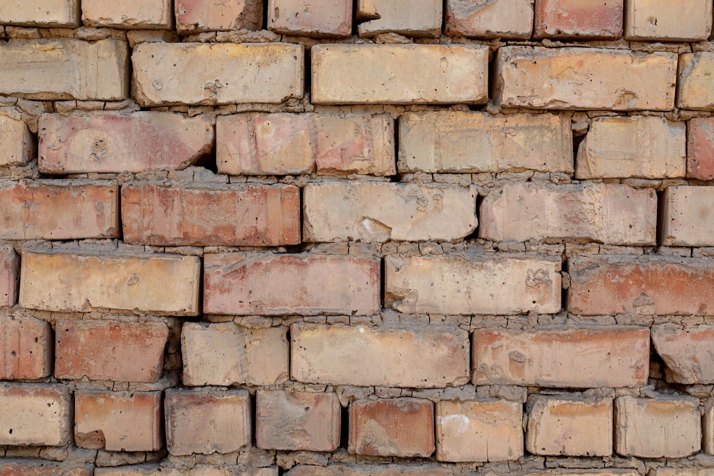 Weathered brick wall ready for repair